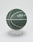 The Live Fast Basketball by LIVE FAST DIE YOUNG is dark green with white lines, made from hygroskopisches PU and has an extra griffige Oberfläche. It features LIVE FAST branding and is shown on a minimalist clear stand against a white background.