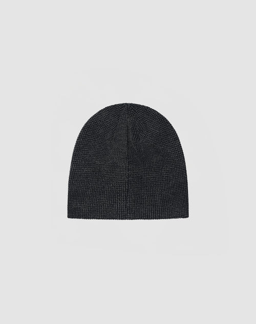 The DY Waffle Beanie by LIVE FAST DIE YOUNG in plain dark gray, made from 100% cotton, features a handcrafted spray effect for a unique look, shown against a light gray background.
