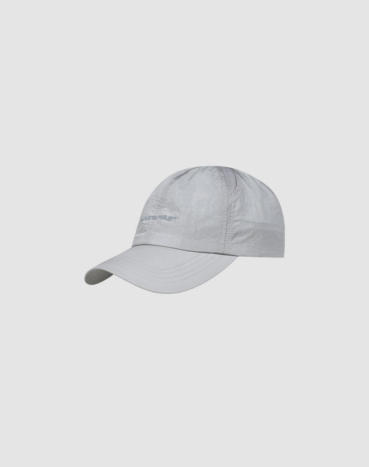 The LFDY Performance Cap by LIVE FAST DIE YOUNG features light gray lightweight nylon, a curved brim, subtle stitching, logo print, and an adjustable strap, displayed on a plain light background.