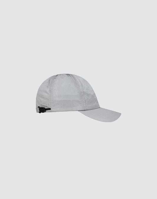 The LFDY Performance Cap by LIVE FAST DIE YOUNG is a light gray baseball hat made from lightweight nylon, featuring a curved brim, subtle logo print, and an adjustable black strap, shown on a plain light background.