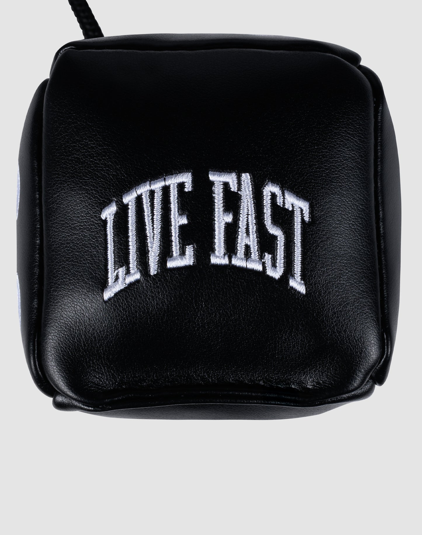 A black PU-leather pouch from LIVE FAST DIE YOUNG, featuring "LIVE FAST" embroidered in bold white arched capitals on the front, designed to hold the LFDY Leather Car Dice.