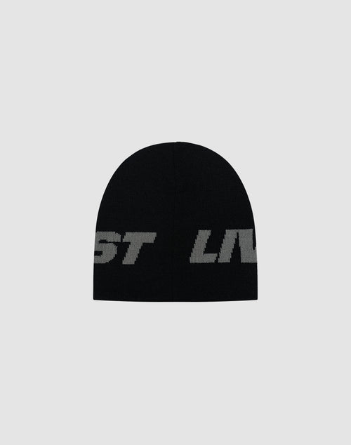The Live Fast Jacquard Beanie by LIVE FAST DIE YOUNG is a black polyacryl hat featuring large, bold gray jacquard logo lettering, partially visible against a plain light gray background. LF2504-17542.