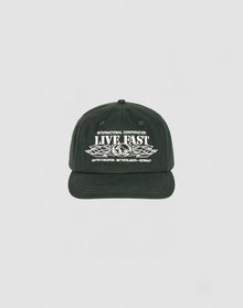 The Live Fast Corporation Cap by LIVE FAST DIE YOUNG is a black 5-panel cap with white INTERNATIONAL CORPORATION LIVE FAST text above wings and country names below, featuring a Multi-Logo design on a plain light background.