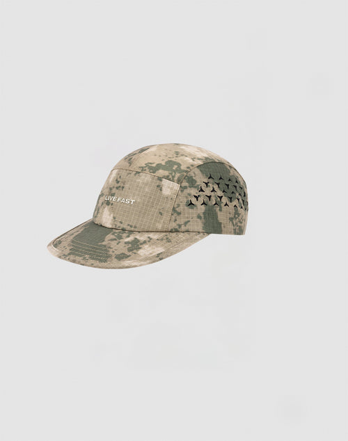 The Live Fast 5 Panel Cap by LIVE FAST DIE YOUNG features a camouflage nylon design with geometric side air holes and LIVE FAST in white silicone print on the front, shown against a plain light background.