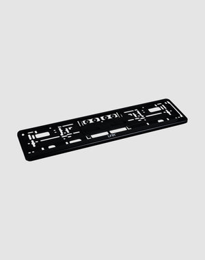 The LFDY License Plate Holder (2 Pack) by LIVE FAST DIE YOUNG is a black plastic Eurokennzeichen holder with multiple mounting slots and holes and a subtle LFDY logo, shown on a light gray background.