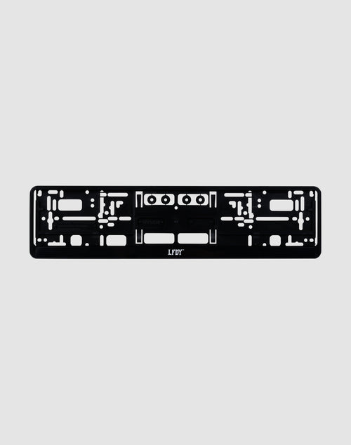 The LFDY License Plate Holder (2 Pack) by LIVE FAST DIE YOUNG features a black plastic design with multiple mounting slots and the white LFDY Logo at the bottom center, ideal for Euro license plates. Displayed on a light grey background.