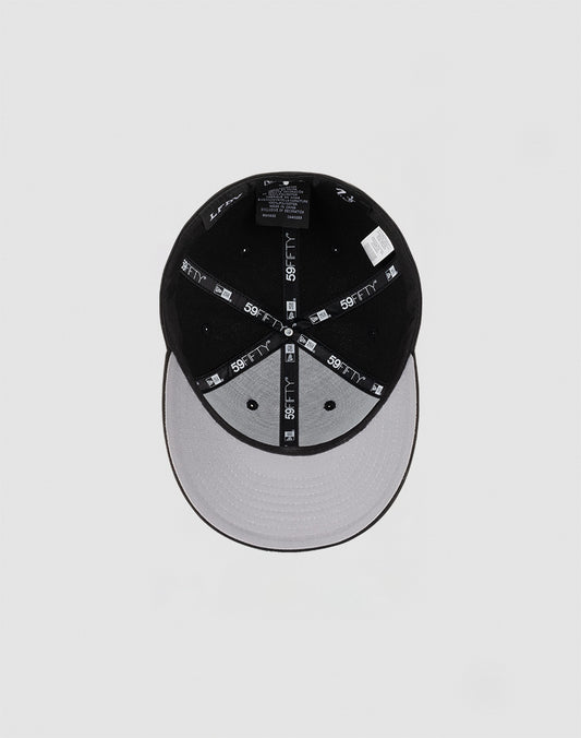 The LFDY x NEW ERA 59FIFTY Low Profile cap by LIVE FAST DIE YOUNG features black panels, a grey underbrim, a low profile silhouette, and branded 59FIFTY taping along the inner seams.