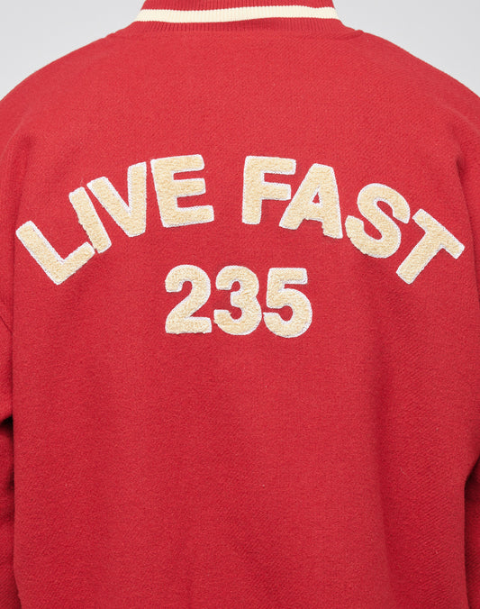 The LFDY OC College Jacket is a red varsity jacket with white trim, Eingrifftaschen, and a bold LIVE FAST Rücken-Stick Frottee-Patch plus the number 235 in large white textured letters on the back.