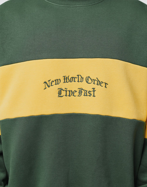 The New World Sweater by LIVE FAST DIE YOUNG is a green, oversized cotton sweatshirt with a bold yellow contrast stripe and New World Order Live Fast in stylized black lettering across the chest.