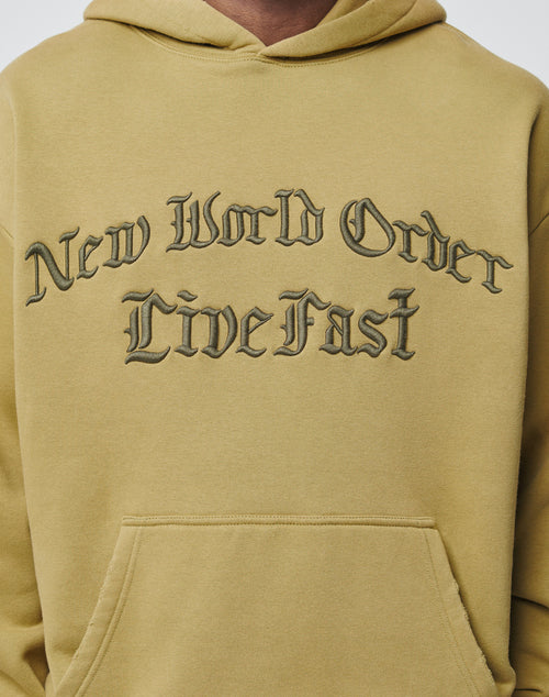 Someone wears an oversize fit New World Hooded by LIVE FAST DIE YOUNG, in light brown with a soft Baumwolle-Polyester blend and New World Order Live Fast printed in black gothic-style font across the chest.