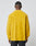 A person faces away from the camera, wearing the bright yellow LFDY Frottee Shirt by LIVE FAST DIE YOUNG with a Hemdkragen and black pants, set against a plain light gray background.