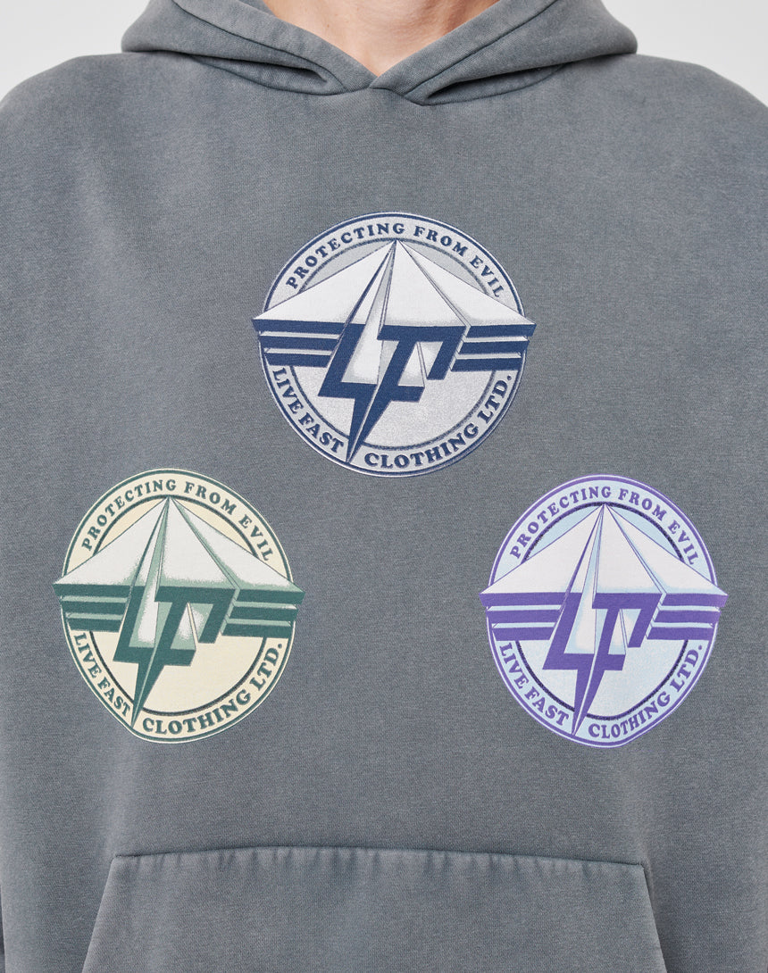 The Triple LF Hooded by LIVE FAST DIE YOUNG is a grey, oversized hoodie with a vintage-effect frontprint: three circular logos reading "Protecting from Evil" in navy, green, and purple color schemes.