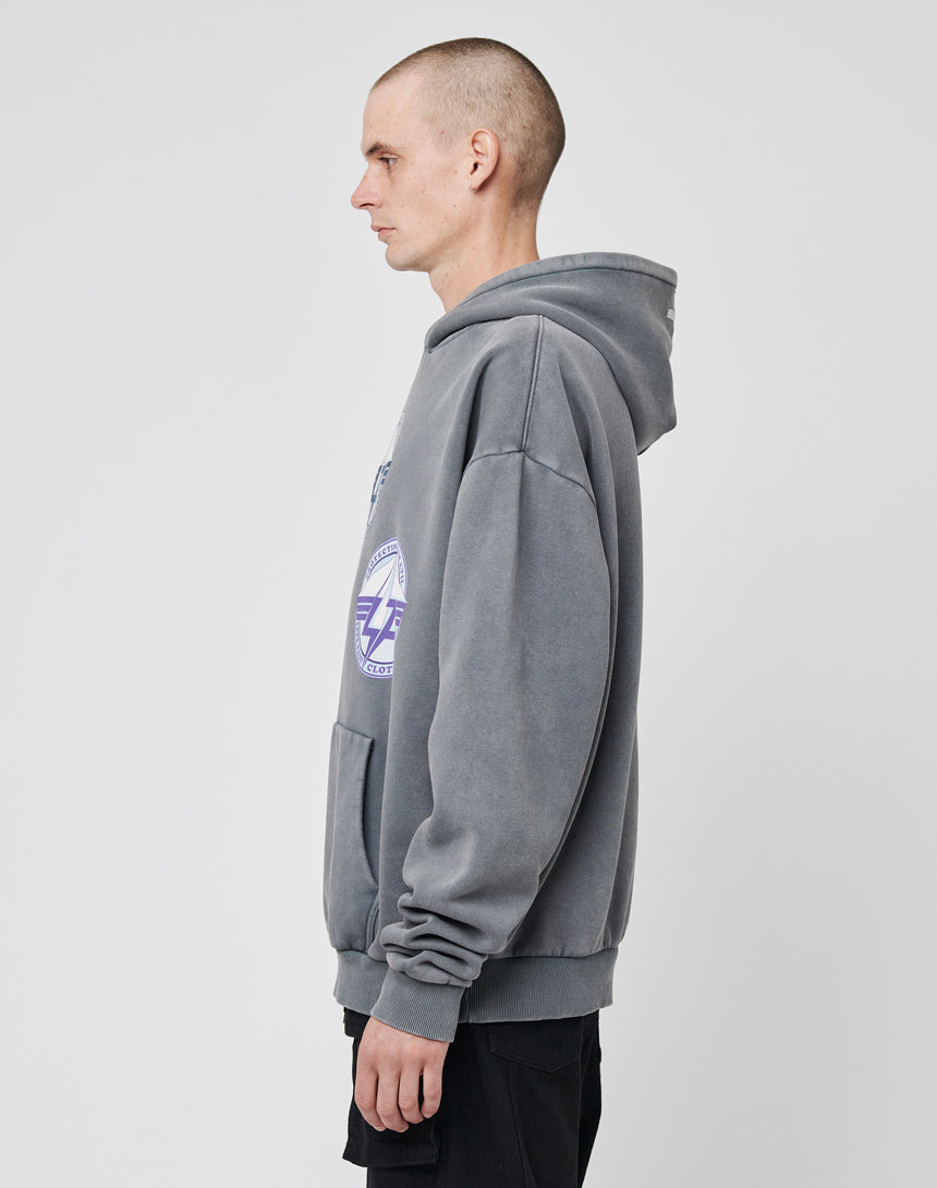 A person with a shaved head stands in profile against a plain white background, wearing the LIVE FAST DIE YOUNG Triple LF Hooded sweatshirt in an oversize fit with a bold frontprint graphic; their arms are relaxed by their side.