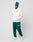 A person wears a LIVE FAST DIE YOUNG Basic Chest Hooded in white, green sweatpants, a matching green beanie, and white sneakers, standing hands-in-pockets against a plain light gray background.