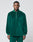 A man faces forward in a green LIVE FAST DIE YOUNG Velvet Halfzip pullover with Metallreißverschluss half-zip and matching oversize-fit pants, set against a plain light gray background.