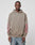 A person wears the LIVE FAST DIE YOUNG Godfathers Hooded, a loose taupe hoodie with pink sleeve writing and blue jeans, standing against a white background. Its oversize fit and Vintage Effekt give it effortless style.