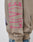 A close-up of the Godfathers Hooded by LIVE FAST DIE YOUNG in beige Baumwolle shows a sleeve with large pink vertical text, worn by someone in blue jeans.