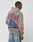 A person wears the LIVE FAST DIE YOUNG Godfathers Hooded, an oversize taupe hoodie with bold red and blue GODFATHERS text and a vintage two-man illustration on the back, All right RESERVED and STYLE on the sleeve, made from a cotton-polyester blend.