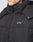 A close-up of a person wearing the Basic Winter Jacket by LIVE FAST DIE YOUNG. The black jacket features a high collar, visible zipper, silver snap buttons, and LFDY™ embroidered in white on the chest.