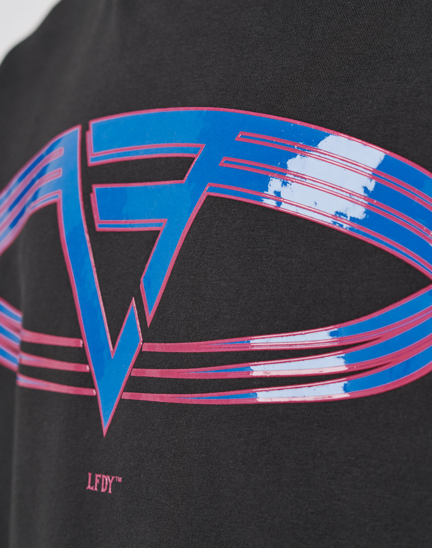 Close-up of the LF Circle Hooded by LIVE FAST DIE YOUNG: a geometric blue and pink graphic on black Baumwolle, featuring overlapping lines, a bold V-shaped design, and distressed white patches for a subtle vintage effect.