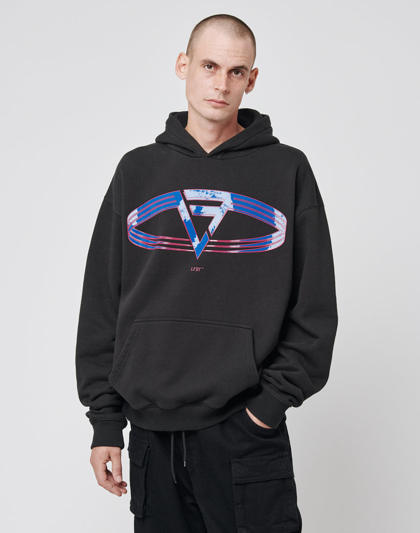Someone wearing the LIVE FAST DIE YOUNG LF Circle Hooded, featuring a colorful geometric design and Oversize Fit, with black cargo pants stands against a plain white background.