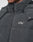 Close-up of a person wearing the LIVE FAST DIE YOUNG Basic Winter Jacket, a dark, wind- and weatherproof padded jacket with a high collar, visible zipper, snap buttons, and the white LFDY™ logo on the chest.