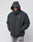 A person wears a thick, dark Basic Winter Jacket by LIVE FAST DIE YOUNG with a hood up and hands in pockets, 1July on the chest. The oversize-fit jacket is styled with gray sweatpants against a plain, light background.