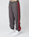 A person wears LIVE FAST DIE YOUNG’s LFDY Trackpants—regular fit gray joggers with red side stripes and a subtle logo-stitch—paired with white sneakers, shown from the waist down against a plain white background.