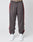 A person wears LIVE FAST DIE YOUNG LFDY Trackpants in regular fit gray with red side stripes, made of polyester, along with white sneakers, standing against a plain light gray background. Only the lower half is visible.