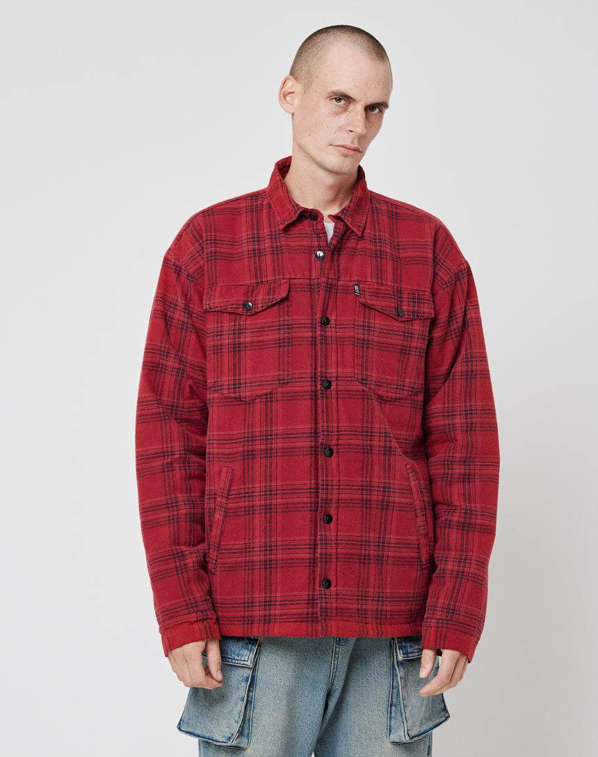 A person in a red plaid Padded Flannel Jacket by LIVE FAST DIE YOUNG and light blue cargo jeans stands against a white background, looking to the side with a neutral expression.