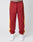 A person wears LIVE FAST DIE YOUNG LFDY Trackpants in maroon polyester with yellow side panels, elastic waistband and drawstring, zippered pockets, paired with white sneakers against a plain light background.