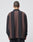 A person with short hair is seen from behind, wearing the LIVE FAST DIE YOUNG LFDY® Polo Longsleeve—an oversized shirt with wide black and brown stripes, Polokragen, and made from 100% Baumwolle—against a light background.