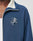 A person wears a blue LIVE FAST DIE YOUNG Track Suit Jacket (Regular Fit) with a white inner collar, white shirt underneath, and features an embroidered skull over crossed baseball bats with Live Fast. Made from polyester baumwolle.