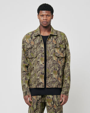 A man stands facing forward, wearing the LFDY Hunter Jacket by LIVE FAST DIE YOUNG in regular fit with flap pockets, matching pants over a black shirt, crafted from 100% cotton, against a plain light gray background.