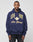 A man wears the LIVE FAST DIE YOUNG Live Fast Campus Hooded, an oversized navy hoodie with a doppellagige Kapuze and yellow and white “LIVE FAST Die Young” text, standing against a plain white background.