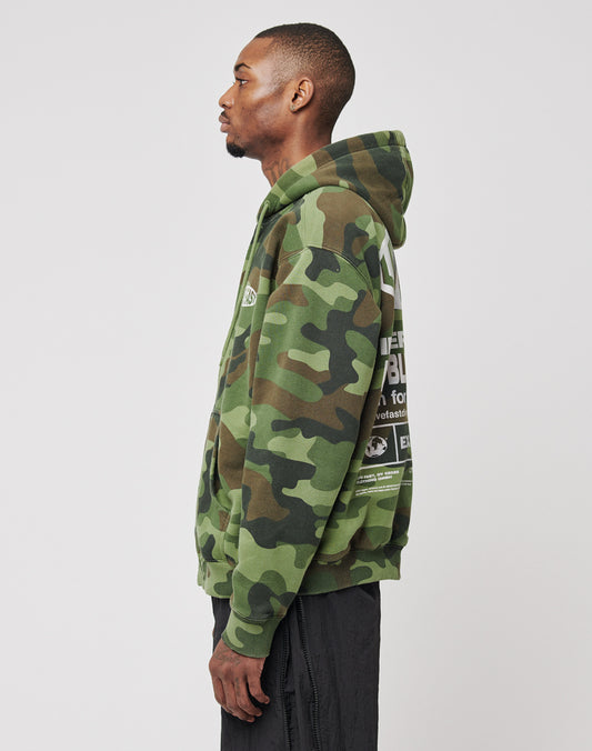 A person stands in profile wearing the LIVE FAST DIE YOUNG LFDY Army Hooded Zip with white text on the back, black pants, and Waffle Innenfutter against a plain light background.