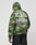 A person wears the LFDY Army Hooded Zip by LIVE FAST DIE YOUNG—a green camouflage oversize hoodie with bold white LIVE FAST text and vintage effect—paired with black pants against a plain light background.
