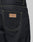 Close-up of the back pocket on LIVE FAST DIE YOUNG Work Denim in Regular Fit, showcasing yellow stitching and a brown leather LFDY patch above the pocket.
