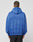 A person wearing a loose-fitting blue Die Trying Hooded by LIVE FAST DIE YOUNG and black pants stands facing away, showing the back of the hoodie against a plain light background.