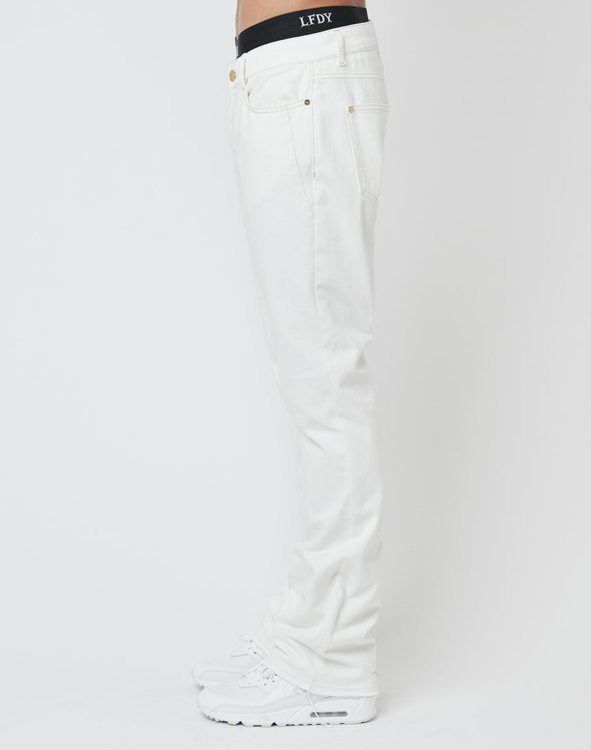 A person wearing Striped Flared Denim by LFDY, white sneakers, and black boxers with LFDY on the waistband, standing sideways against a plain white background.