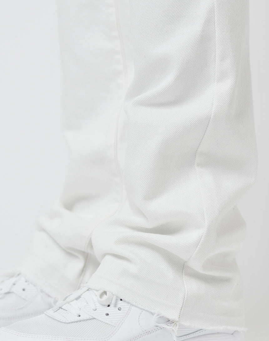 Close-up of the lower legs of a person wearing LFDY Striped Flared Denim and white sneakers, with the pants slightly bunched around the ankles against a plain white background.