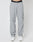 Someone wears LFDY Calf Zip Pants in light gray, loose-fit nylon with an elastic waistband and drawstring, LFDY branding, and a side pocket. They pair the pants with white sneakers against a plain white background.